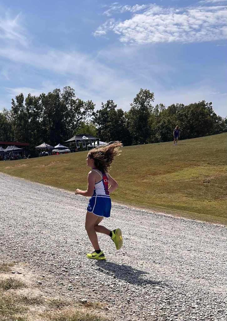 one student running down a dirt road