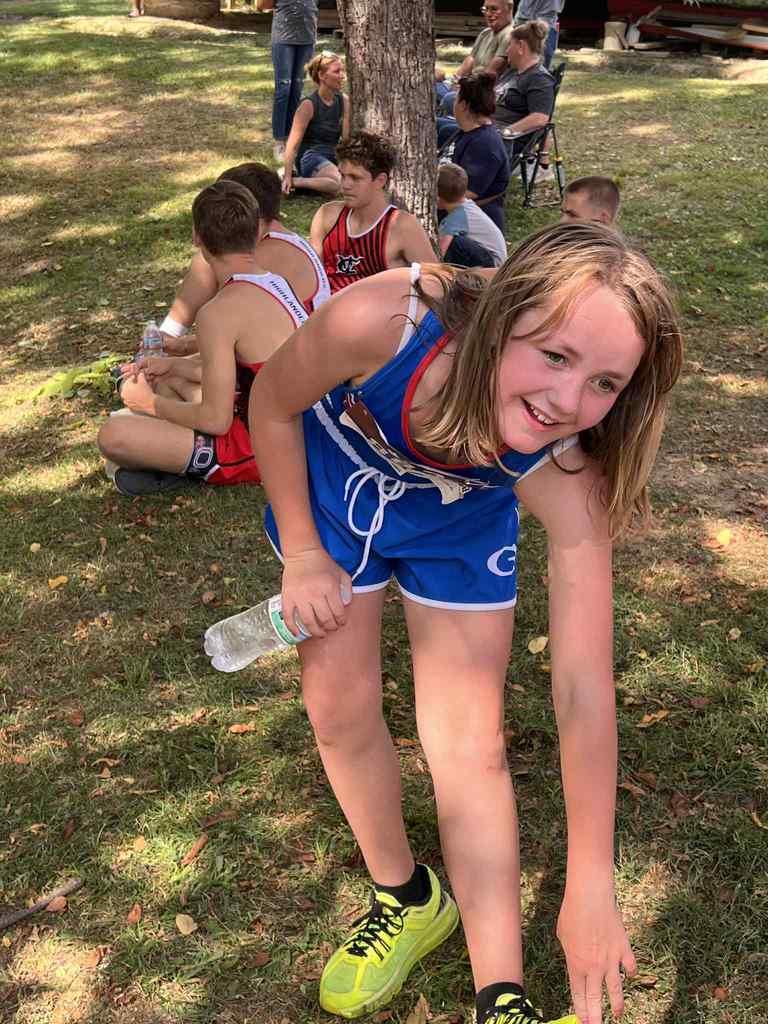 student checking her shoes before the run