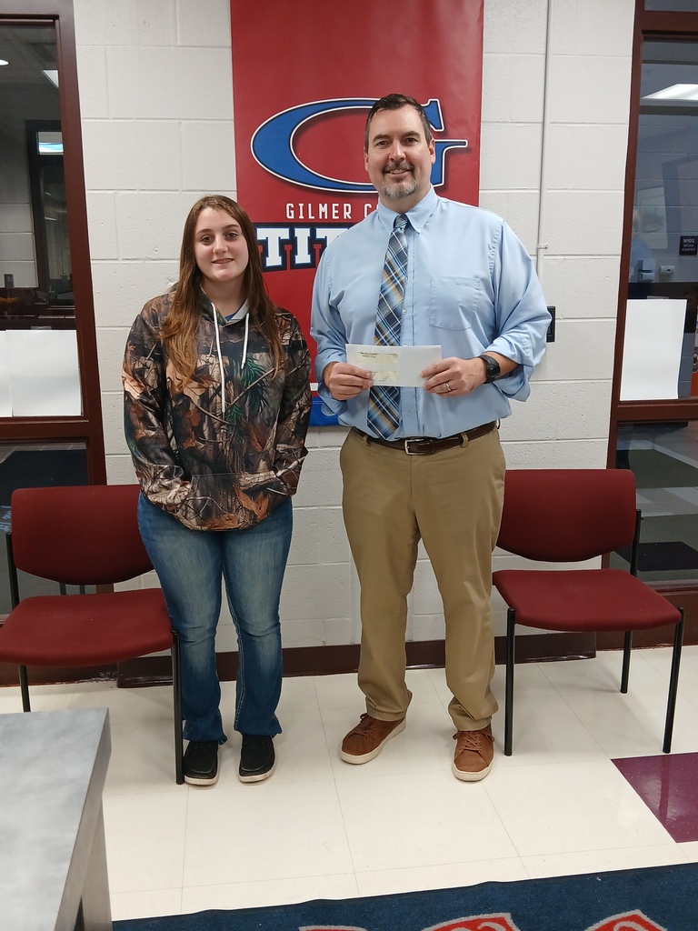 Mr. Fox and Lillijana Richards posing with check