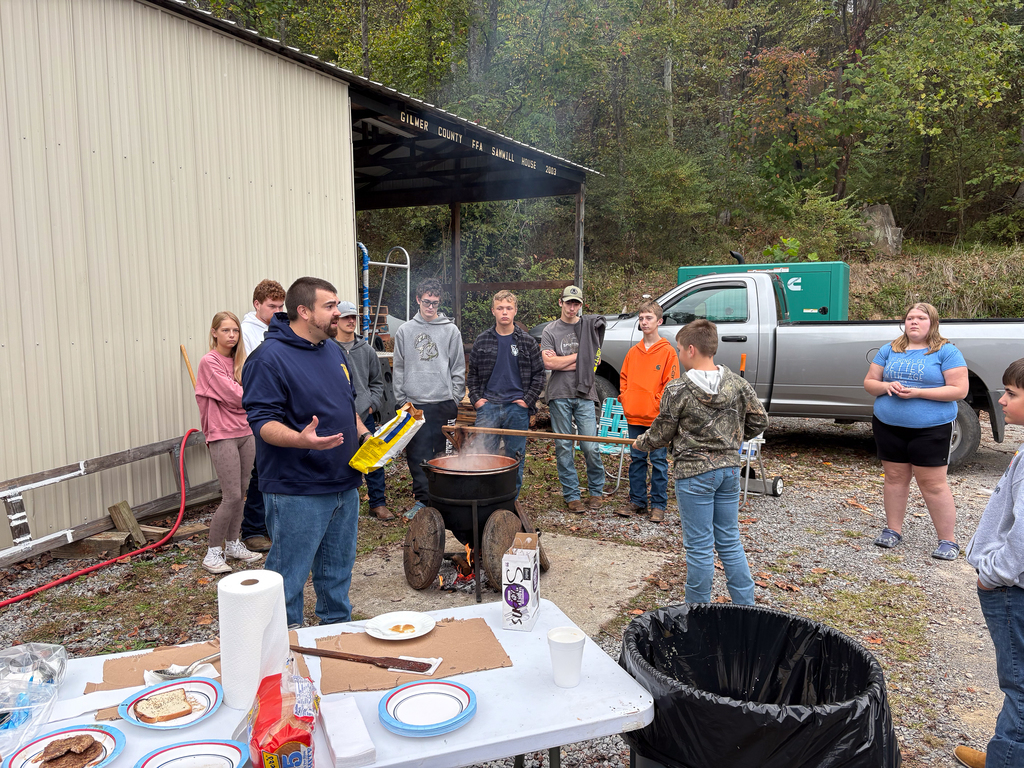 Mr. Cox instructing students on how apple butter is made