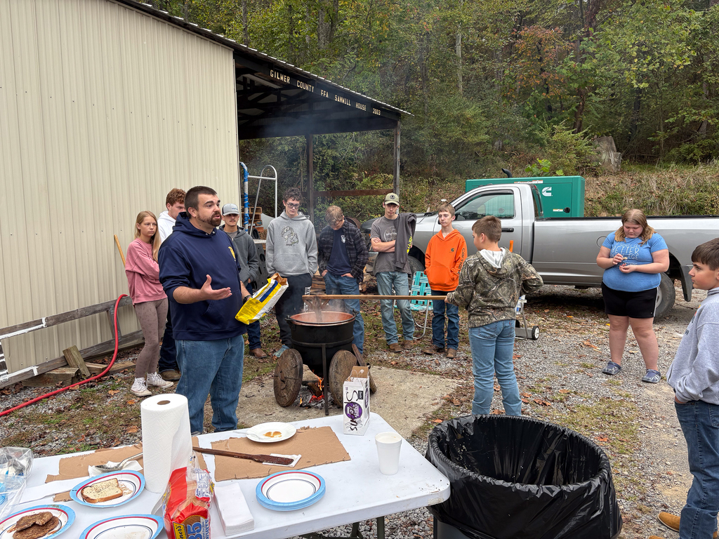 Mr. Cox instructing students on how apple butter is made