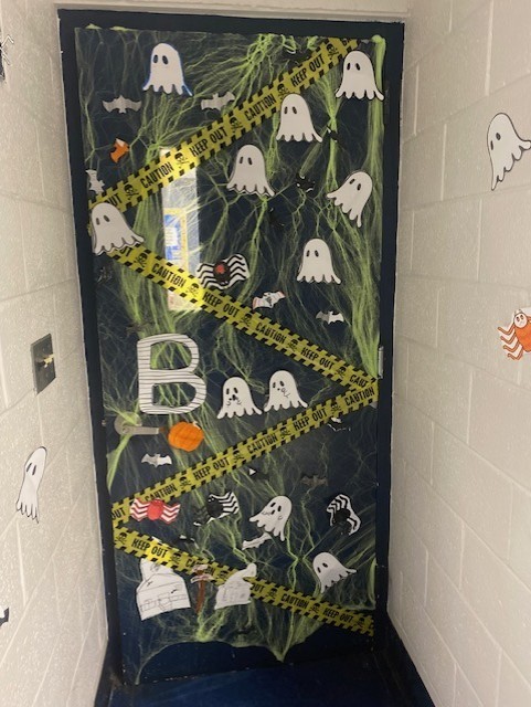 door covered in ghosts and caution tape