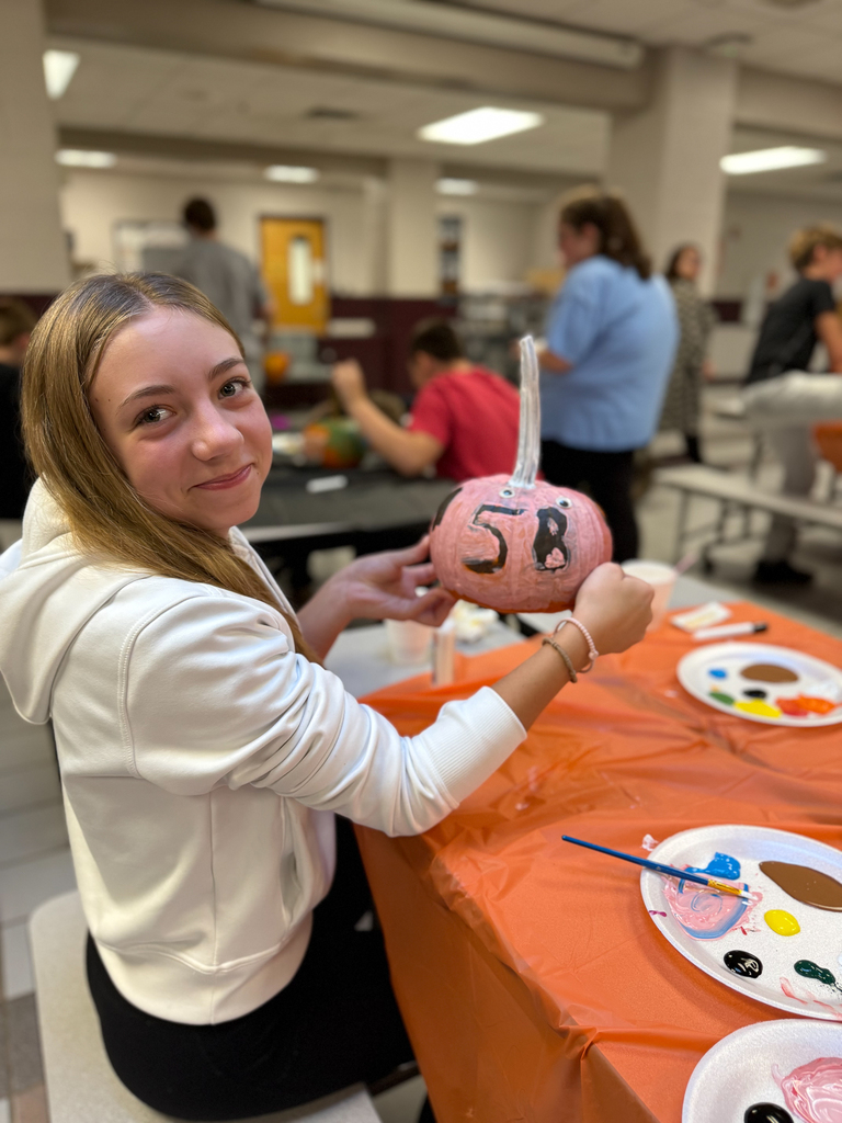 student with "5B" drawn on her pumpkin