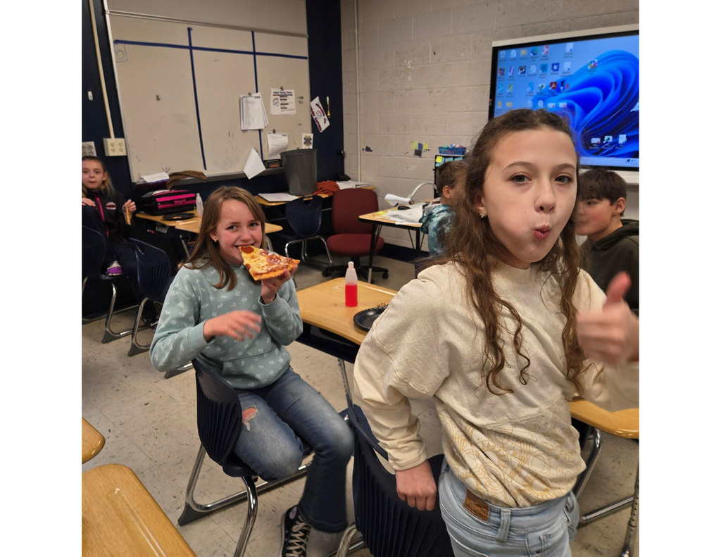 group of students enjoying pizza