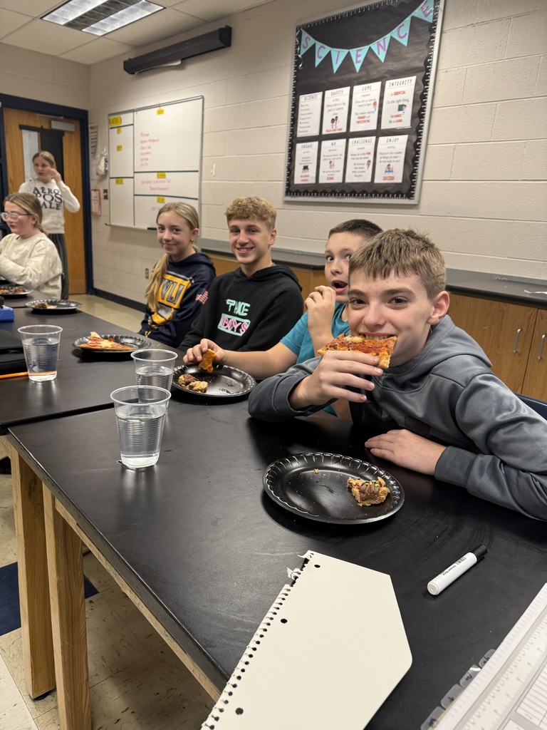 four students enjoying pizza