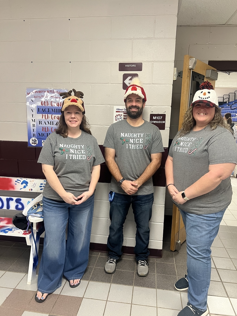 Mrs. Jones, Mr. Wolfe, and Mrs. Conrad with festive hats on