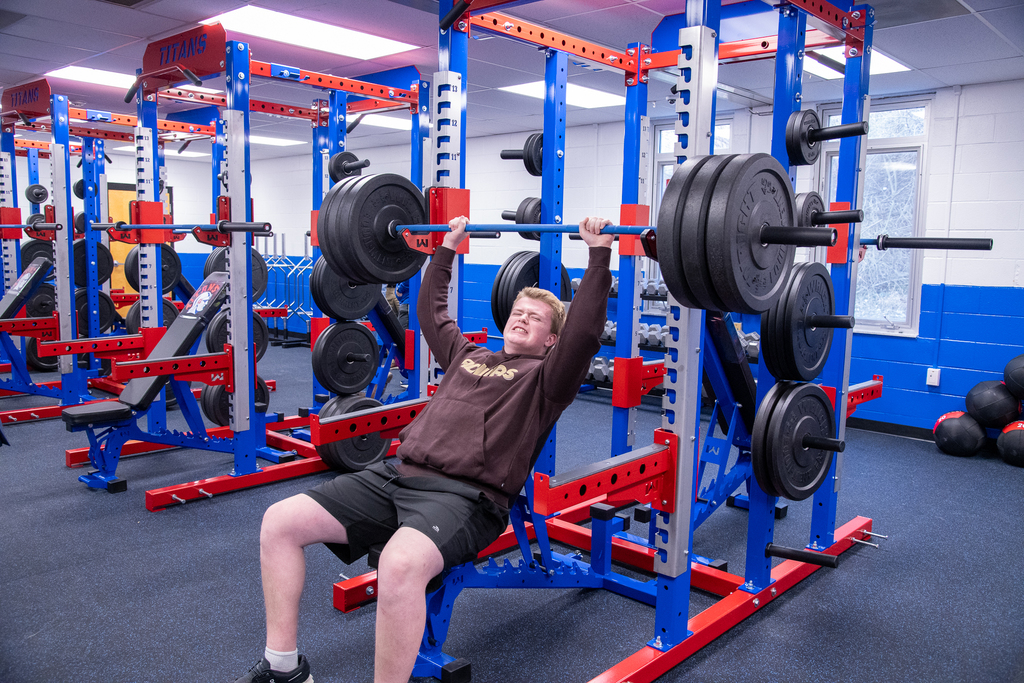 a student lifts weights