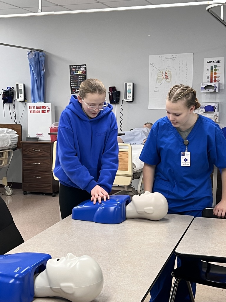 two students with a cpr dummy