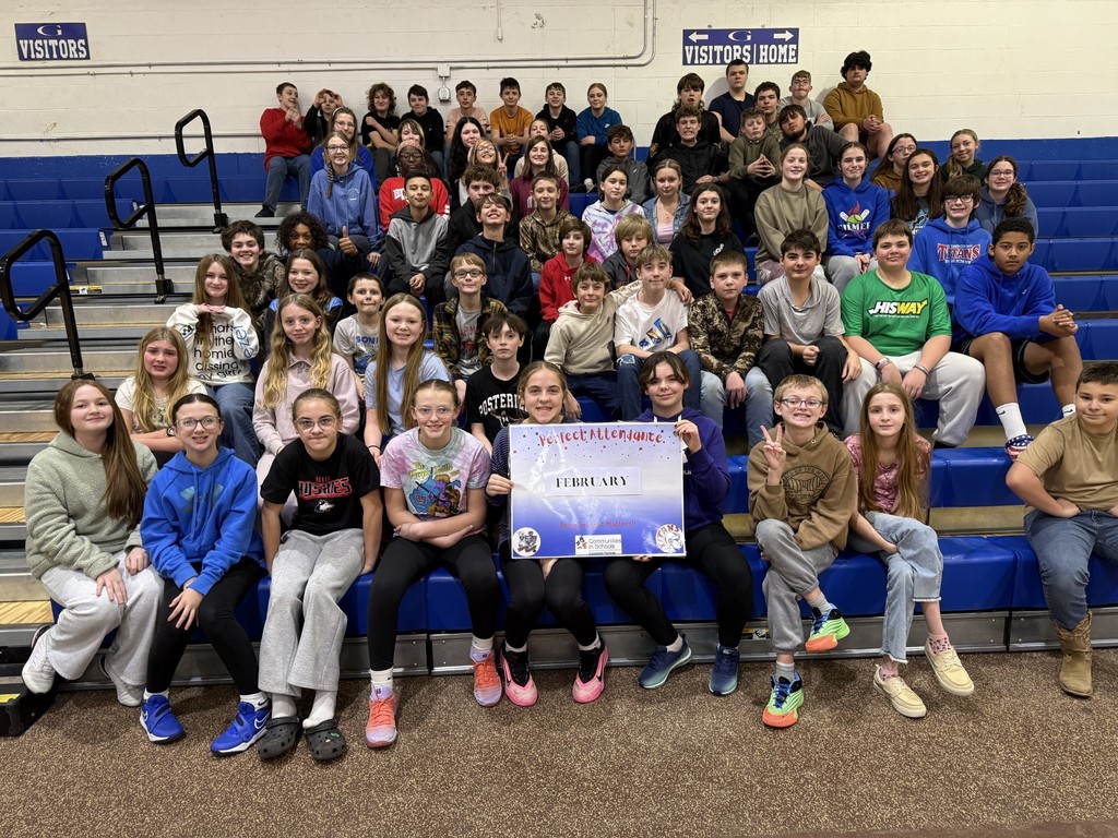 A large group of 77 middle schoolers with a banner that reads: Perfect attendance - Februrary