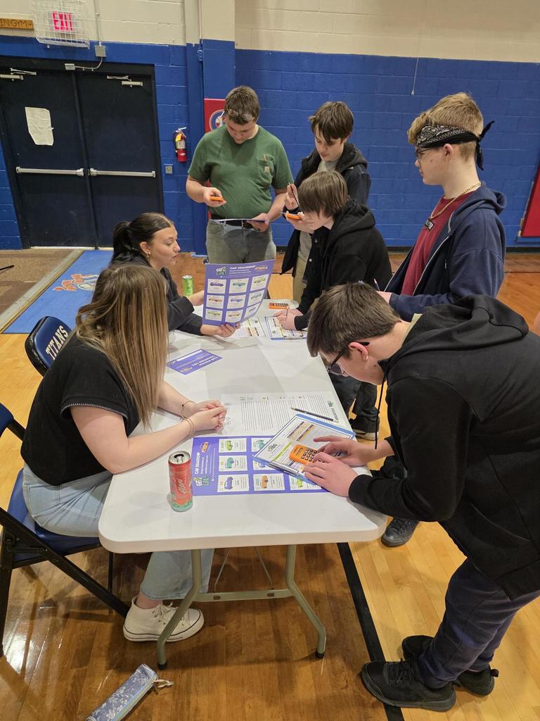 students at a table filling out cards