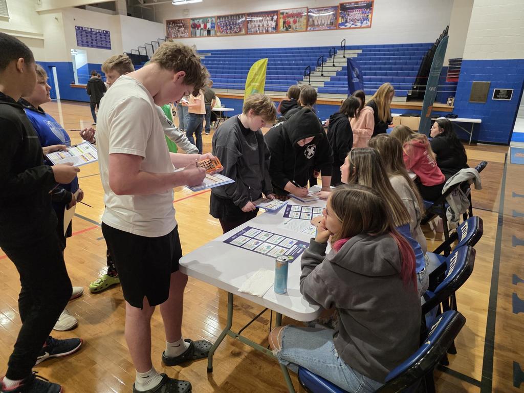 students at a table filling out cards