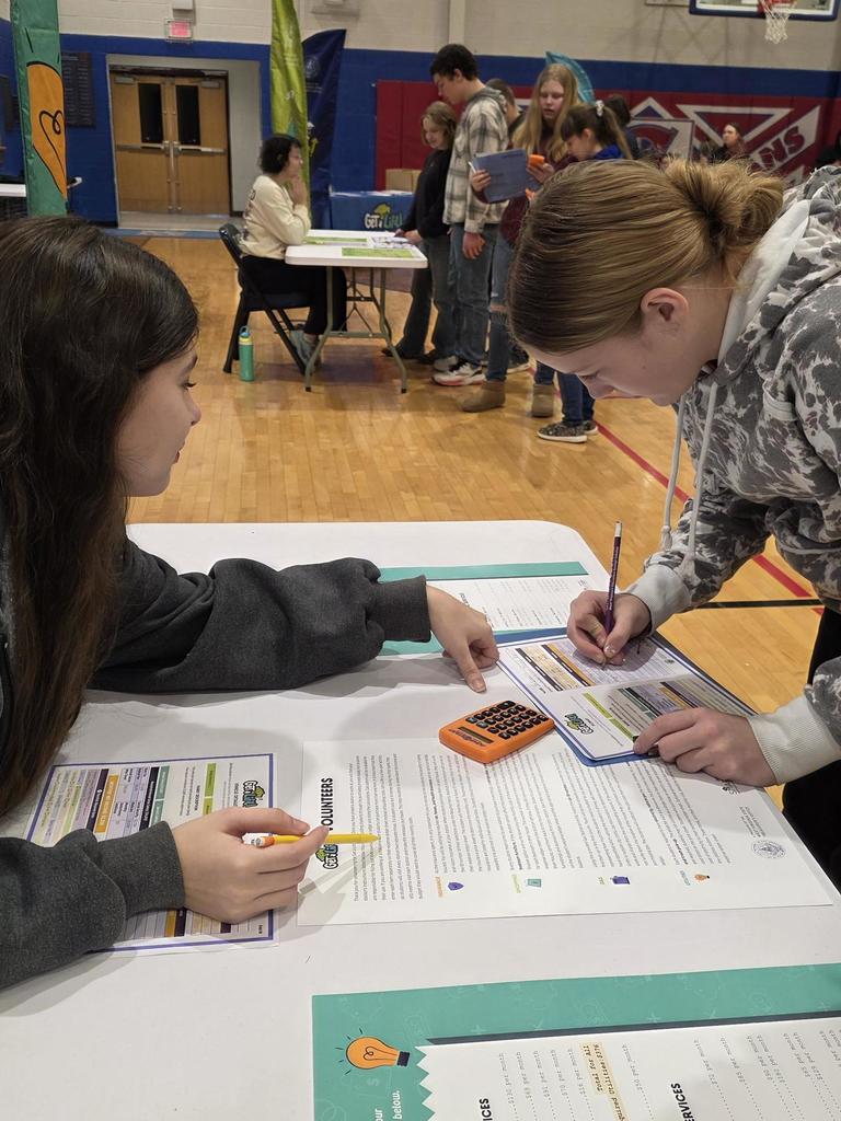 student using a calculator to work out a budget