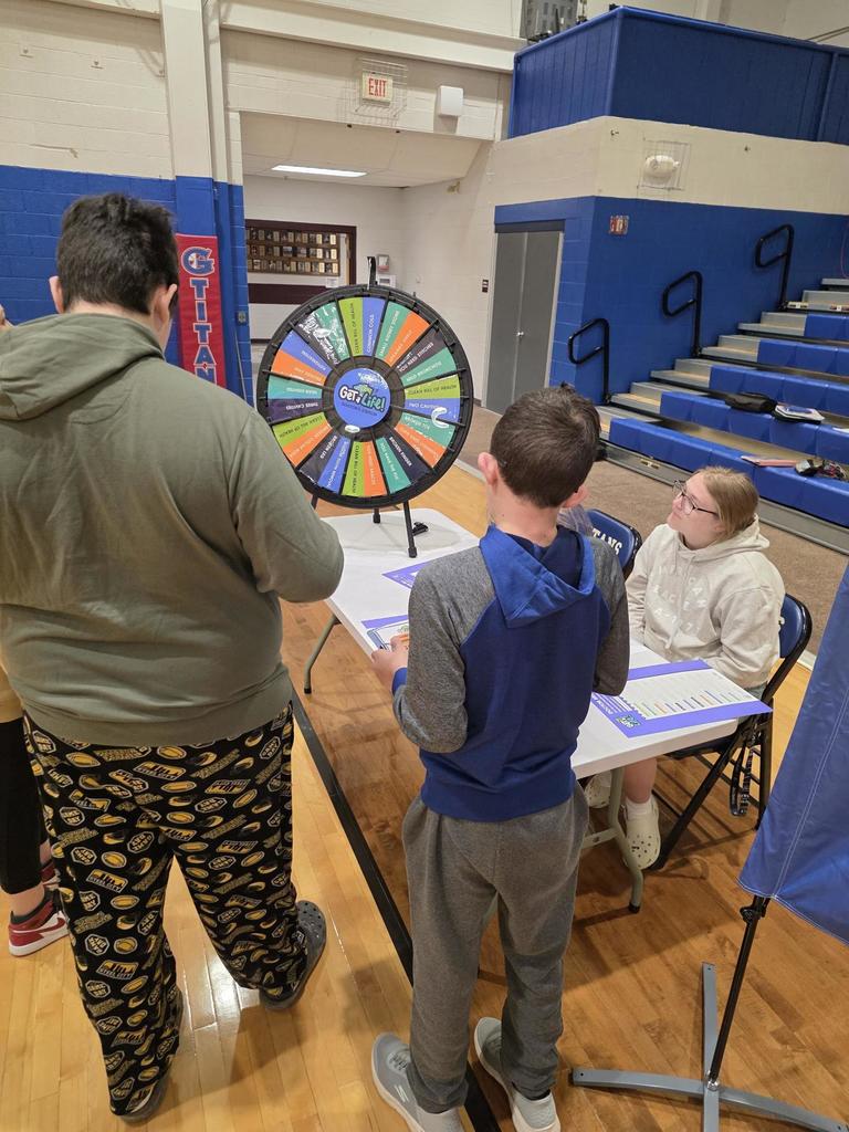 students at a wheel spinner