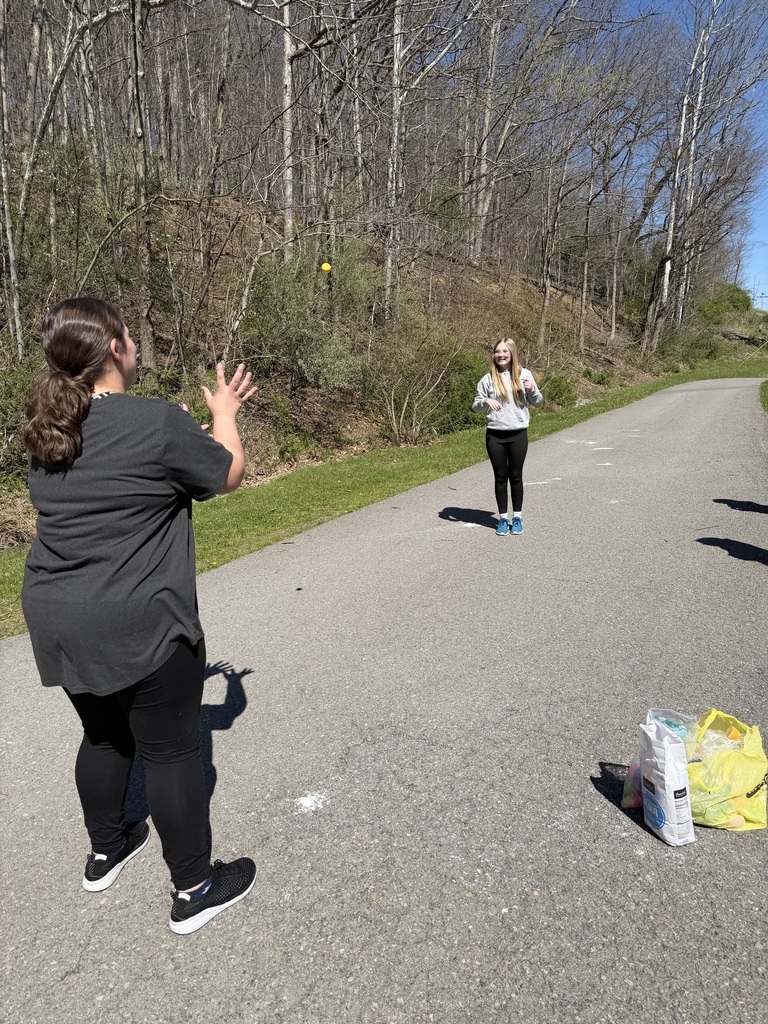 egg in mid air between two students