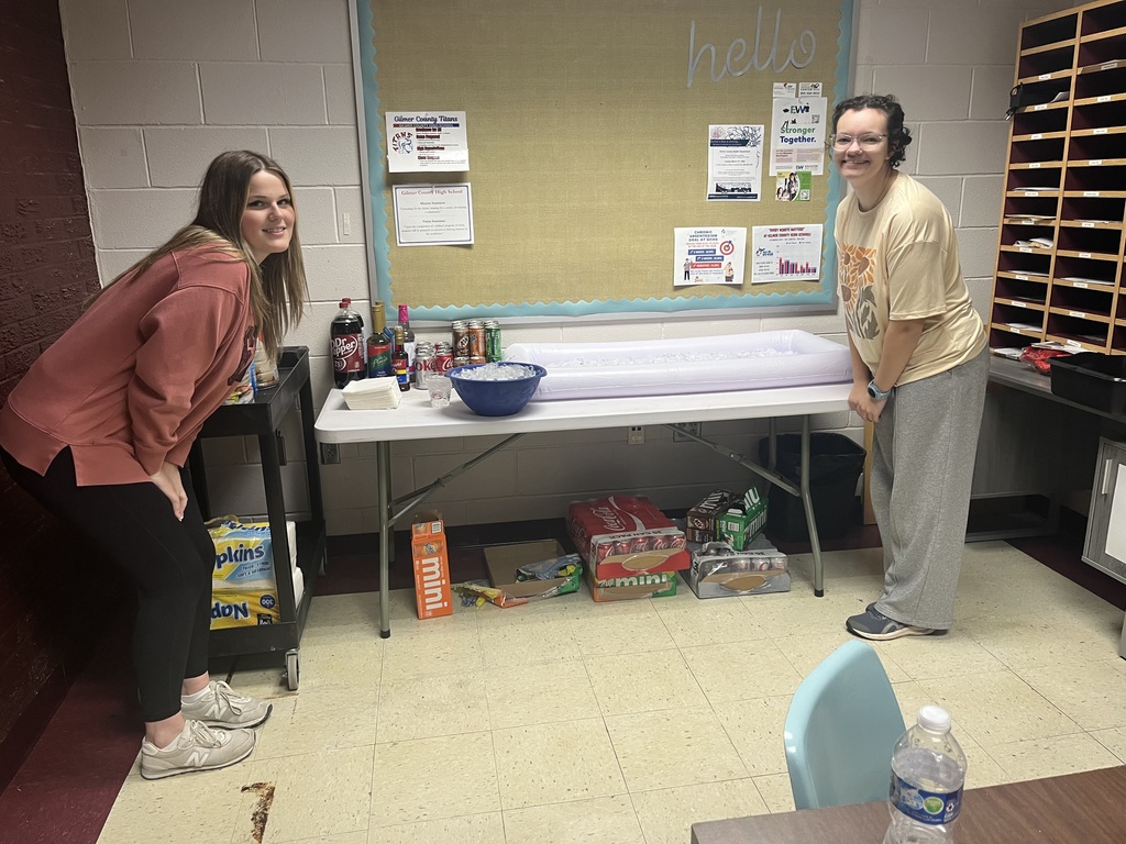 two students posing with the dirty soda bar