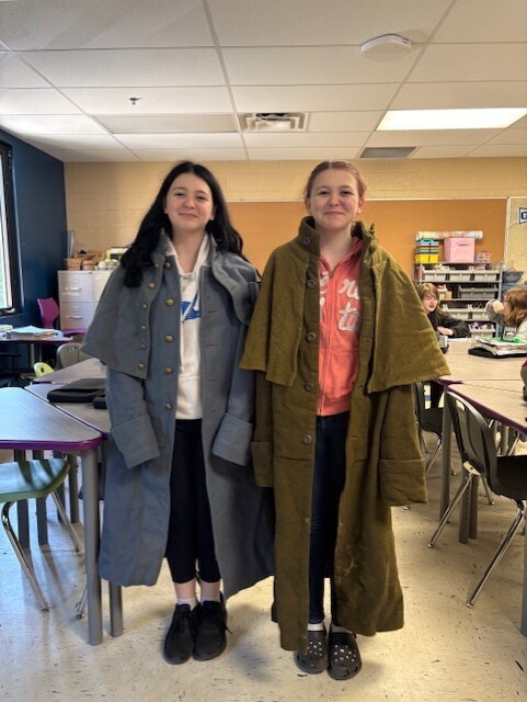 two students posing with civil war attire on