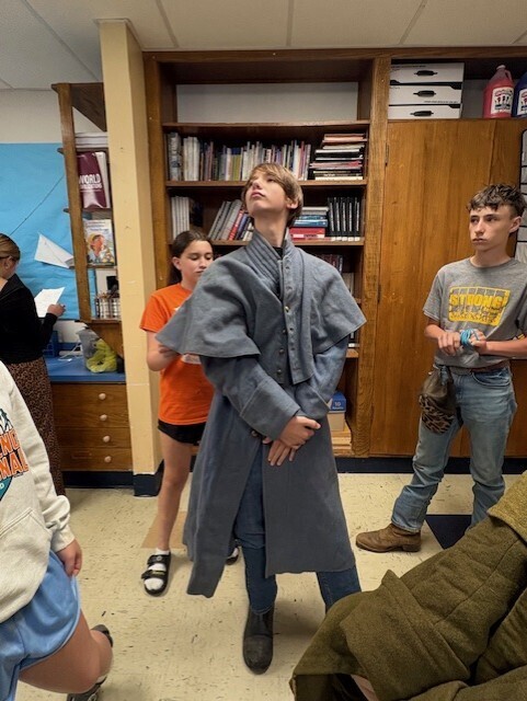 a student posing with a civil war jacket on