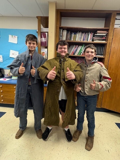 three students posing with civil war attire on