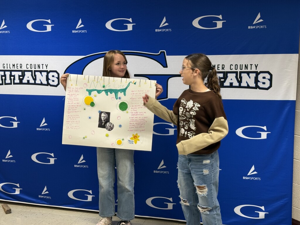 student with a poster about marie curie