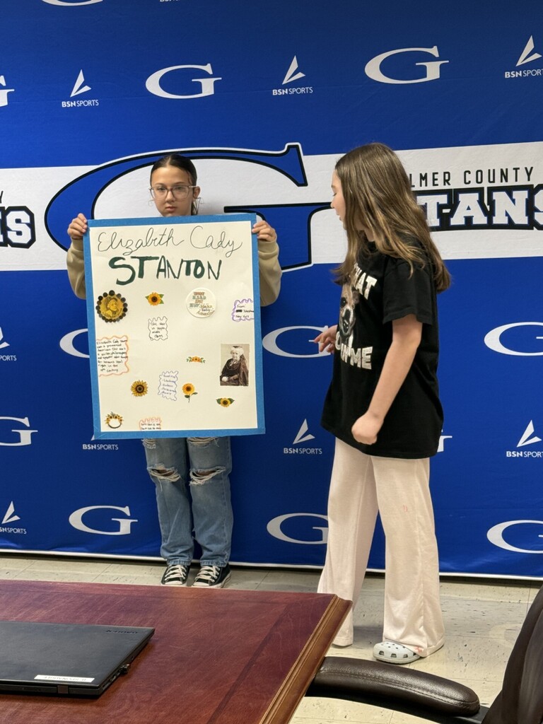 students with a poster that is about "elizabeth cady stanton"