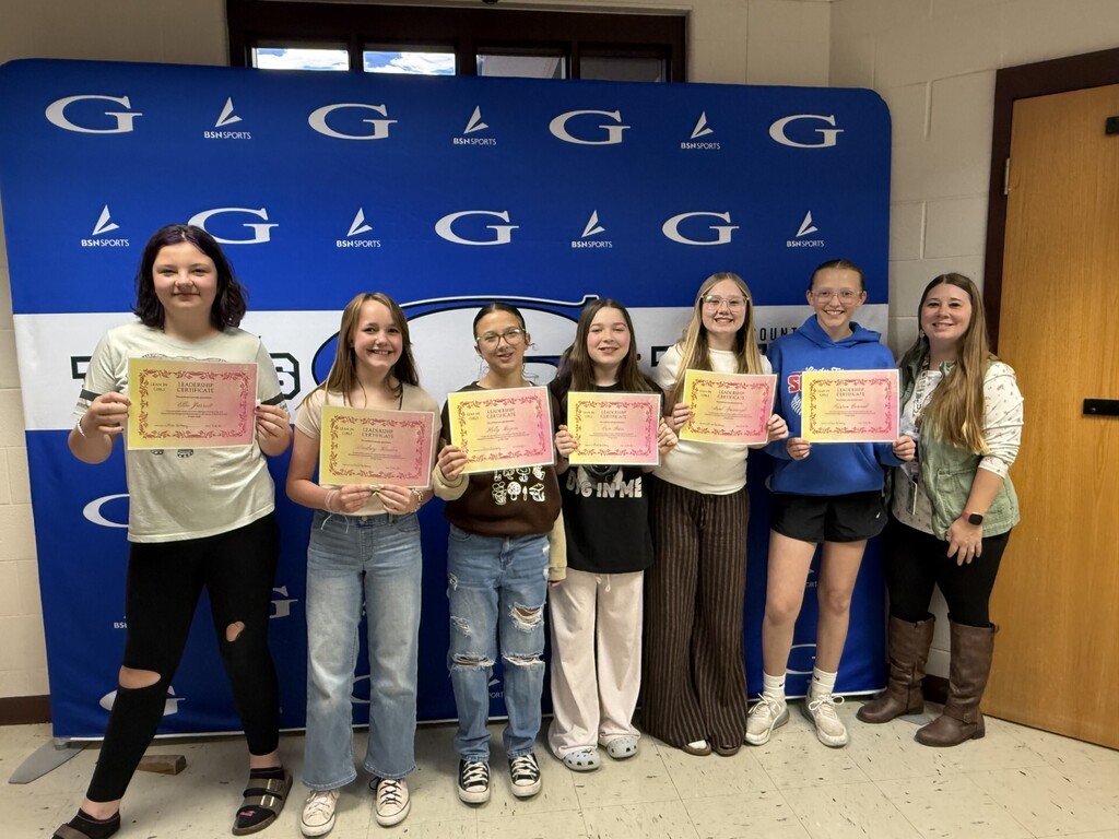 students all posing with certificates of completion