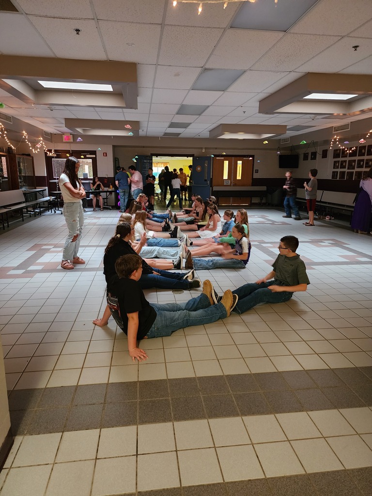students on the floor doing a dance routine
