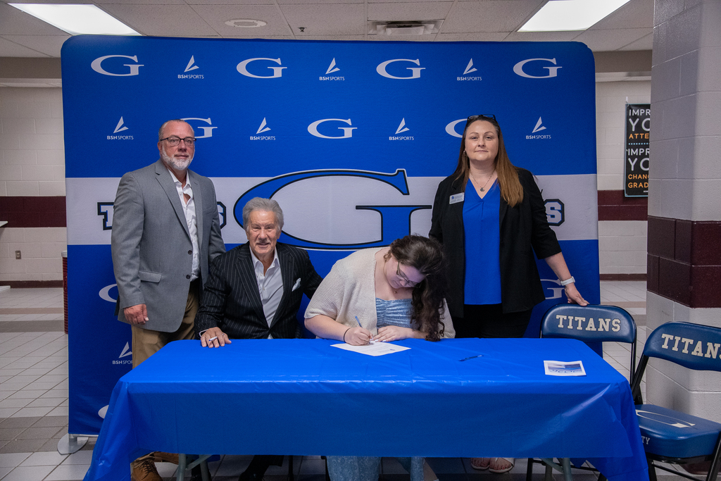 Bella Grijalva signing her intent for GSU -- Dr. Mark Manchin and others in the photo - wide shot