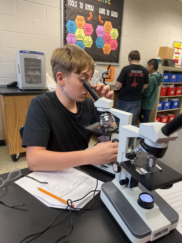 student with microscope