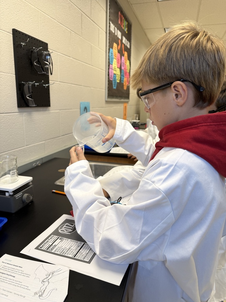student pouring liquid in a graduated cylinder