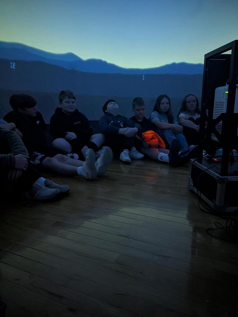 students smiling inside the starlab