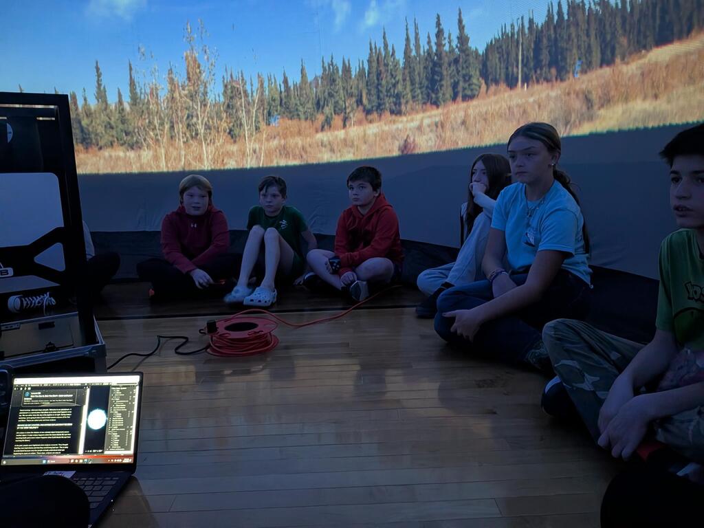 students smiling inside the starlab
