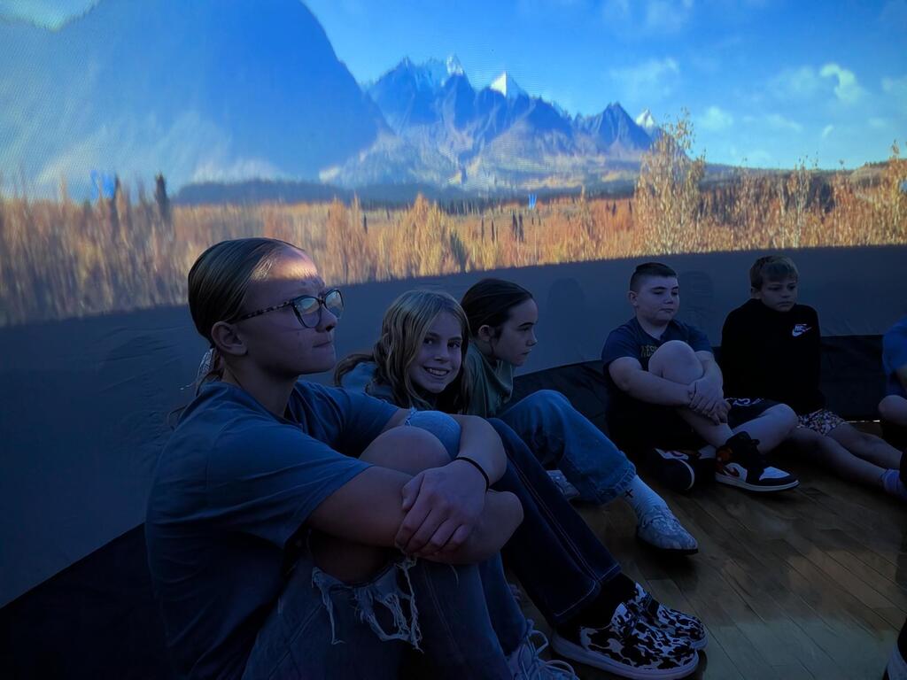 students smiling inside the starlab