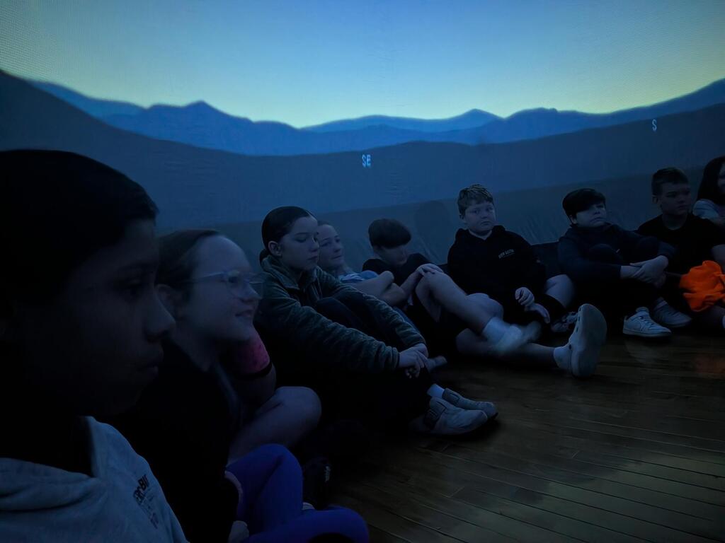 students smiling inside the starlab