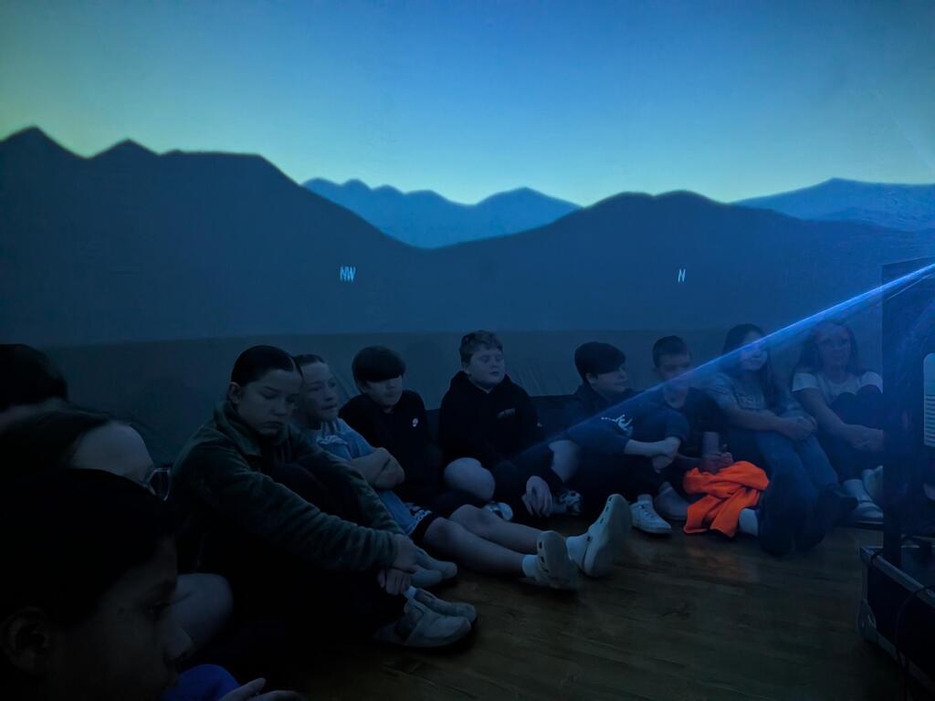 students smiling inside the starlab