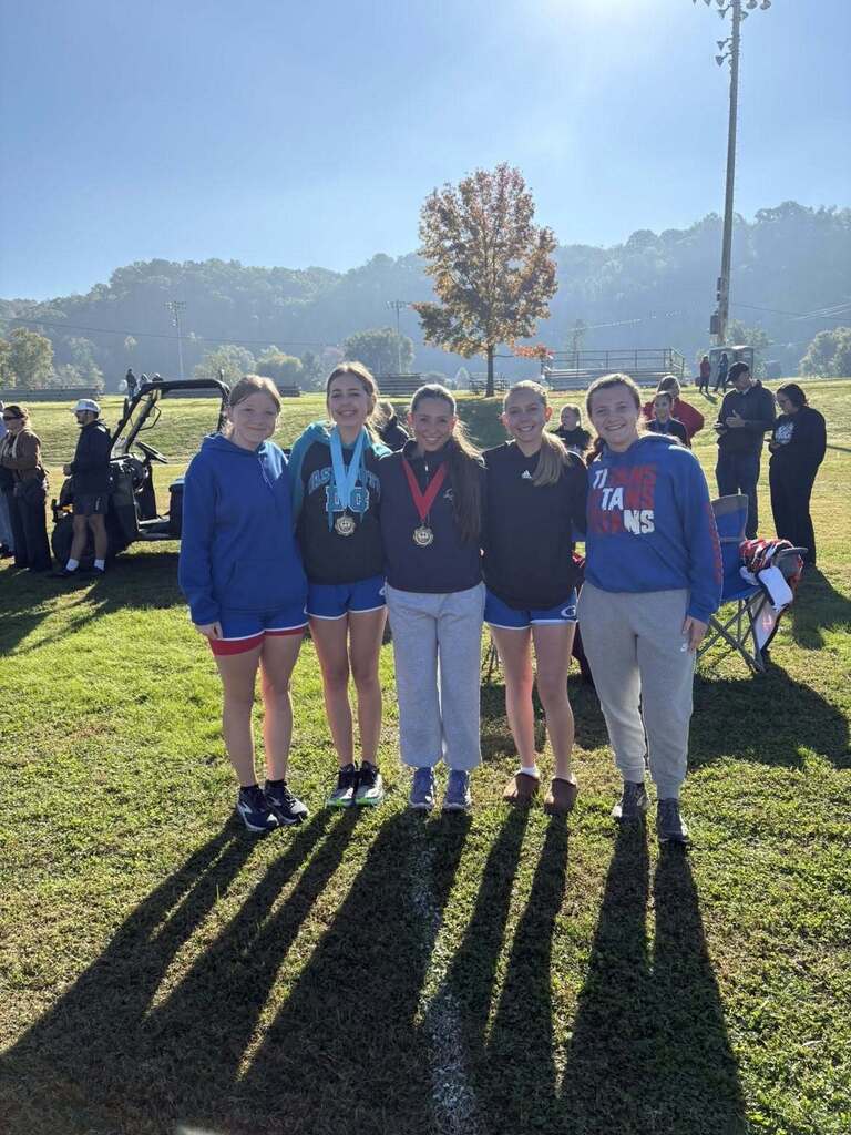 Photo of girls cross country teams with medals