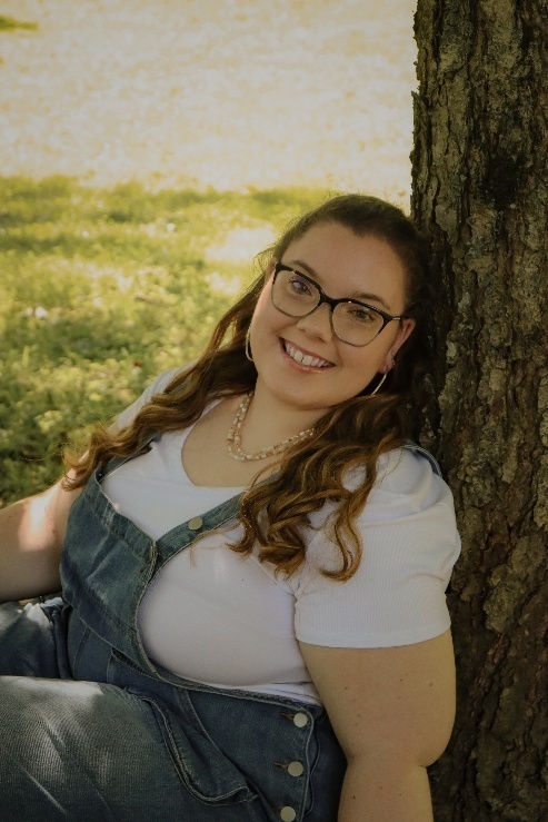 Photo of Kinley Minigh beside a tree