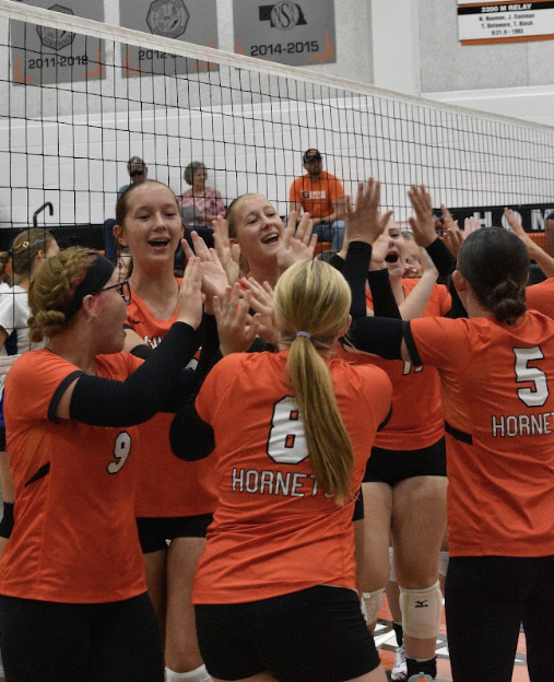 Hornet volleyball team high fiving