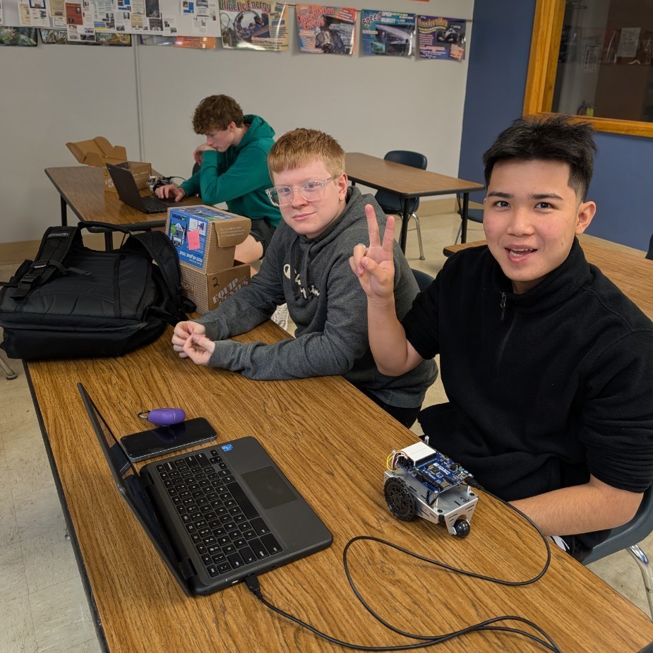 Hugo and Orion working on code for the challenge.