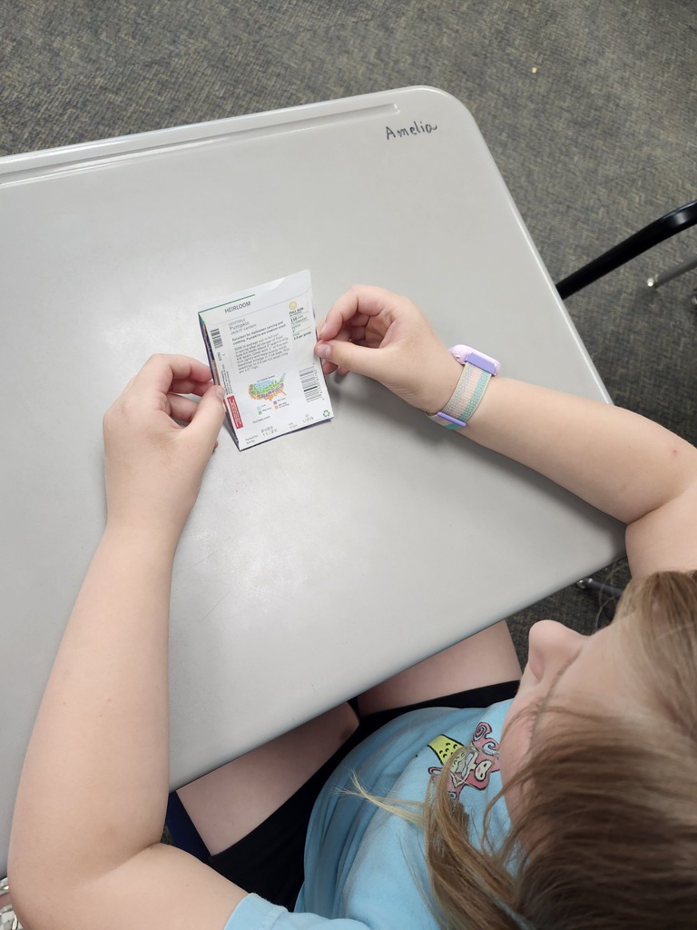 Reading the back of a seed packet.