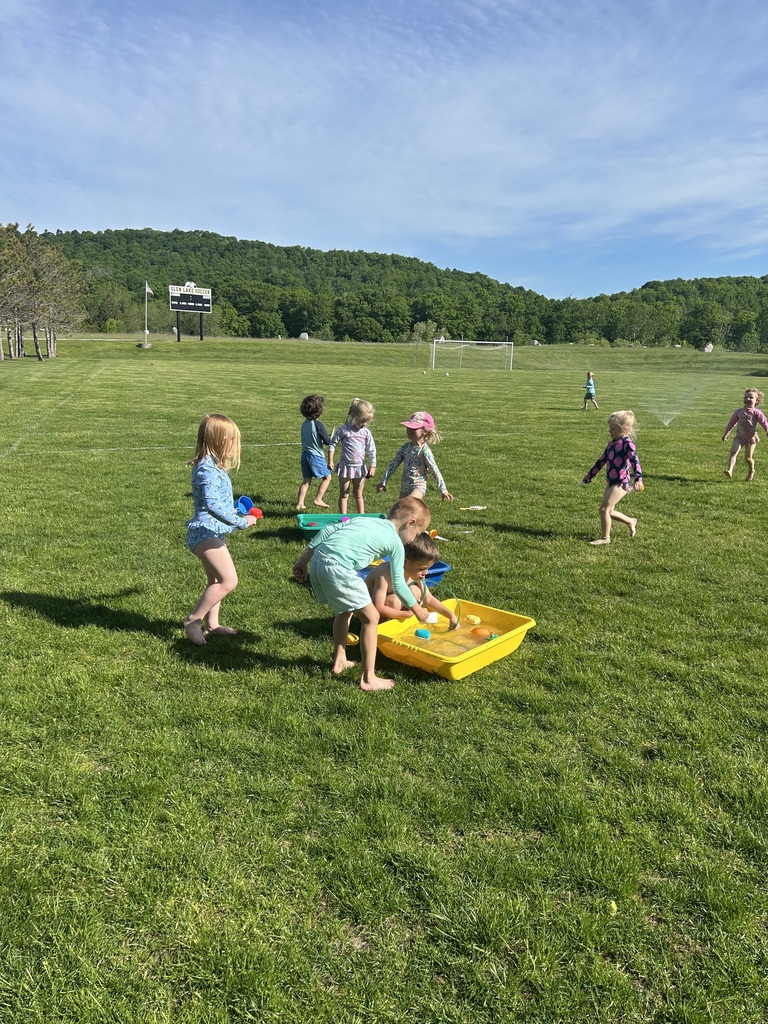 Preschoolers having a water balloon toss