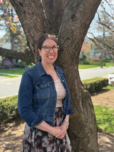 Lauren Carter ToY Byrd standing outside by tree smiling