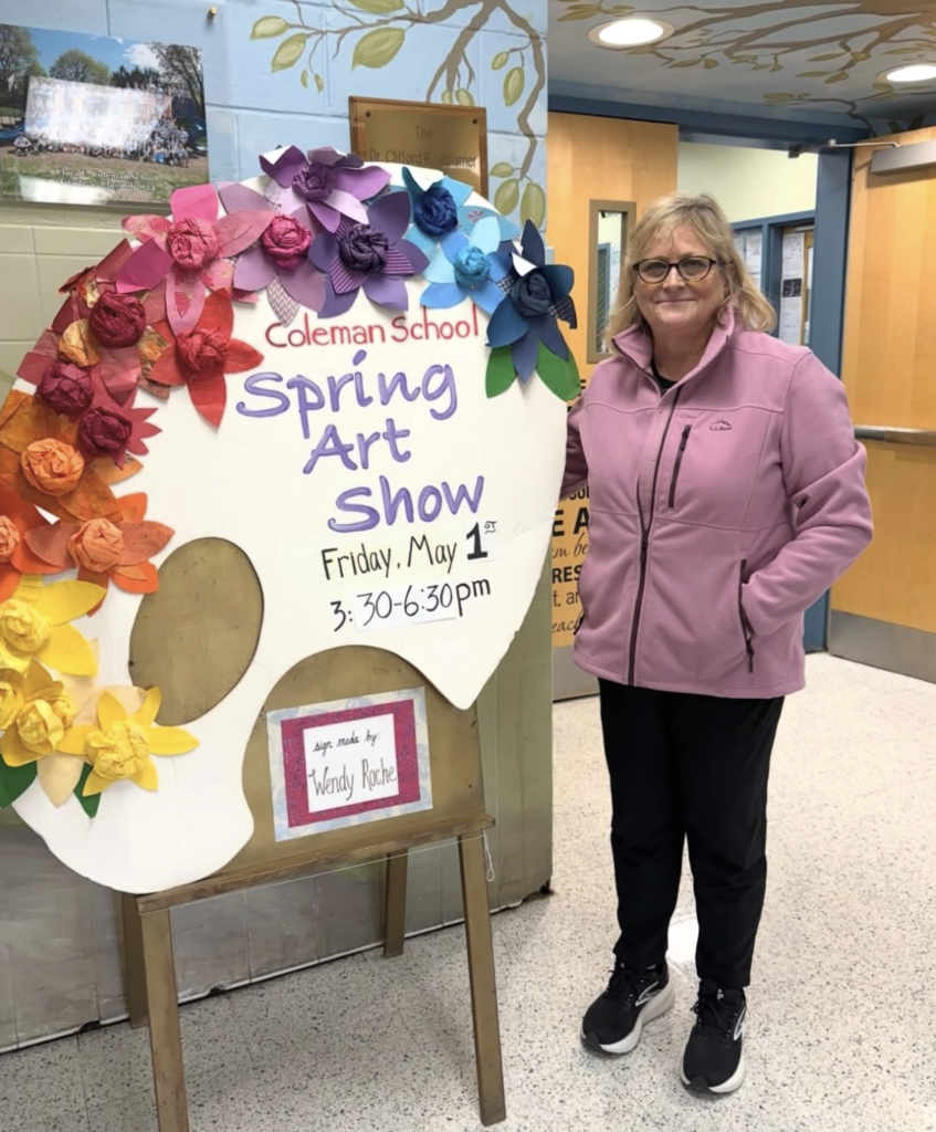 Mrs. Menke with Spring Art Show Sign
