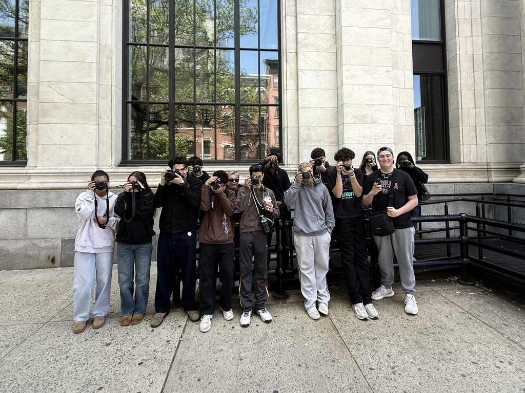 Honors Photography students holding up cameras in Hoboken