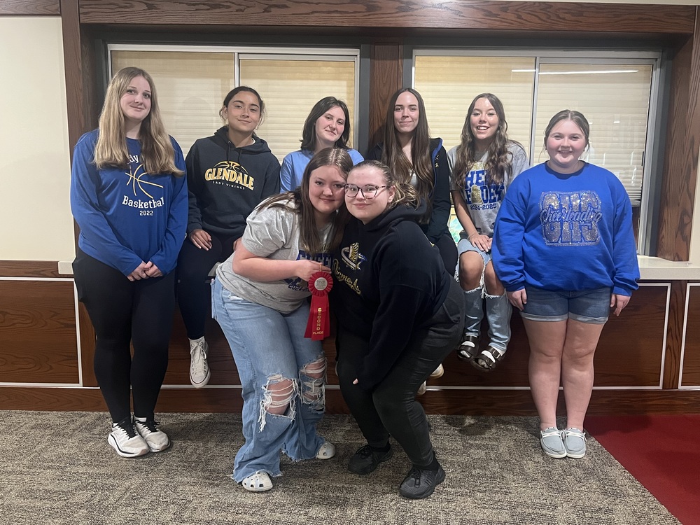 students holding a ribbon