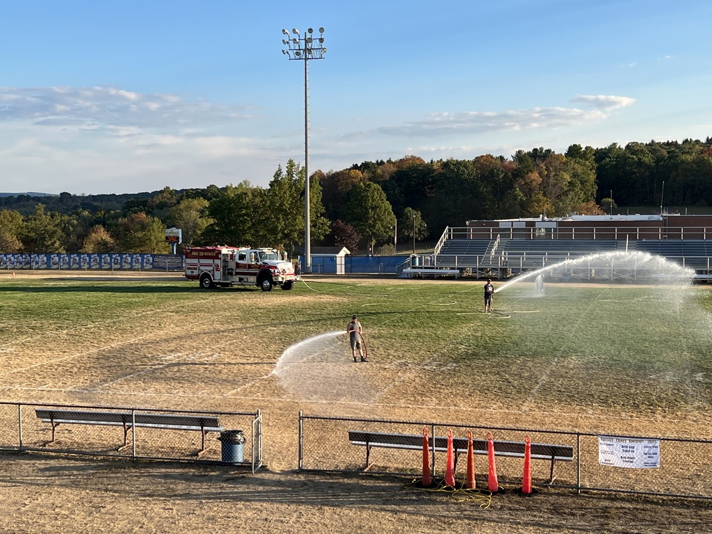 fire trucks watering field
