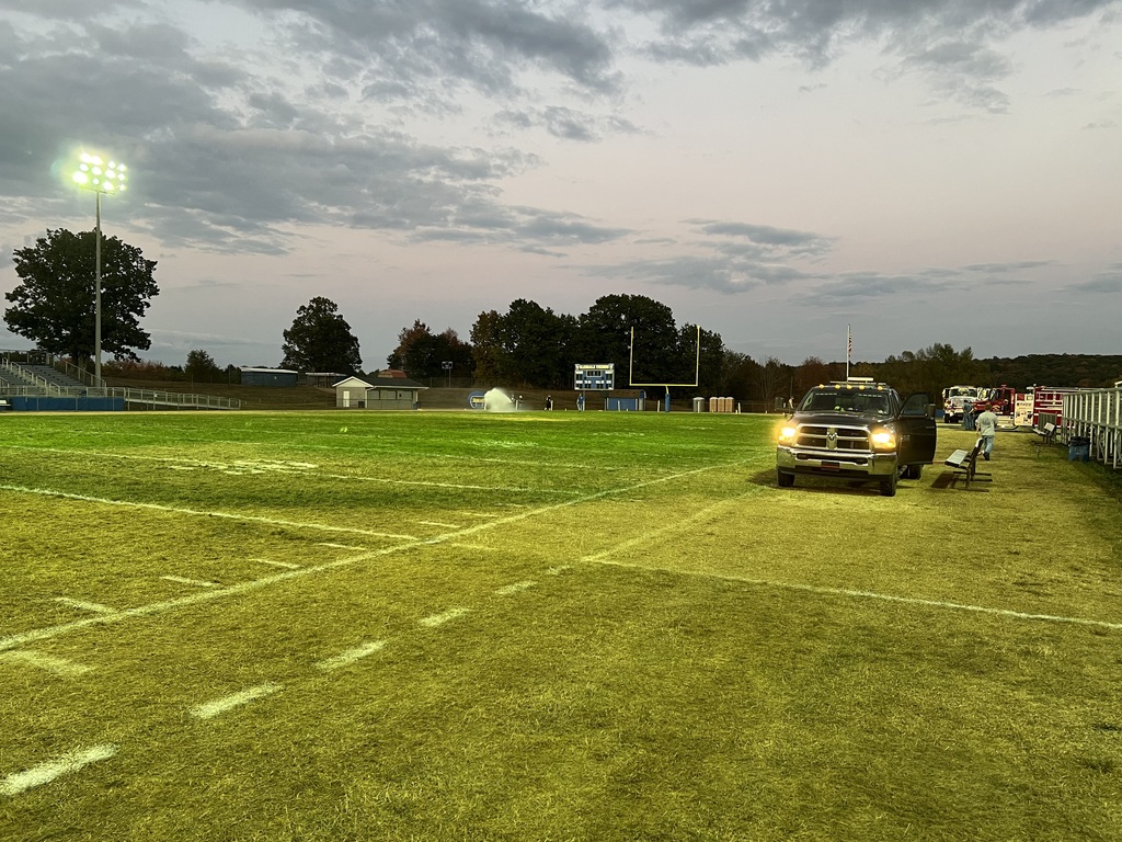 fire trucks watering field