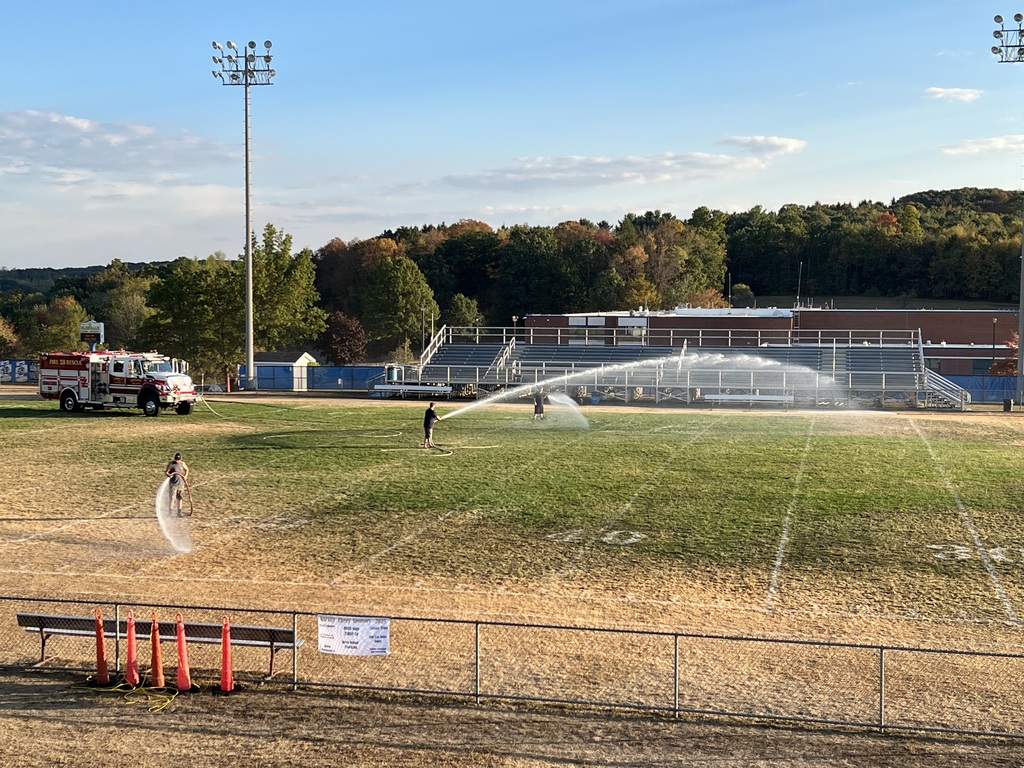 fire trucks watering field