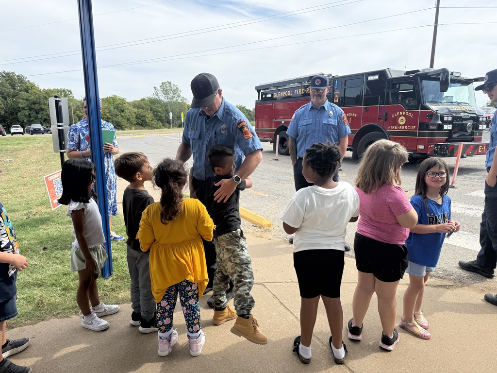 Children visiting with fire fighters
