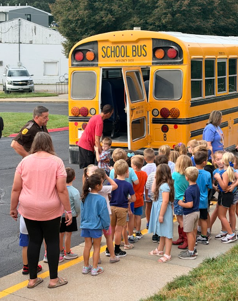 Bus Evac Drill Trooper speaking with bus load of students