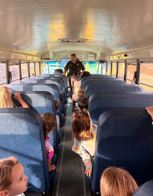 Bus Evac Drill Trooper speaking with bus load of students